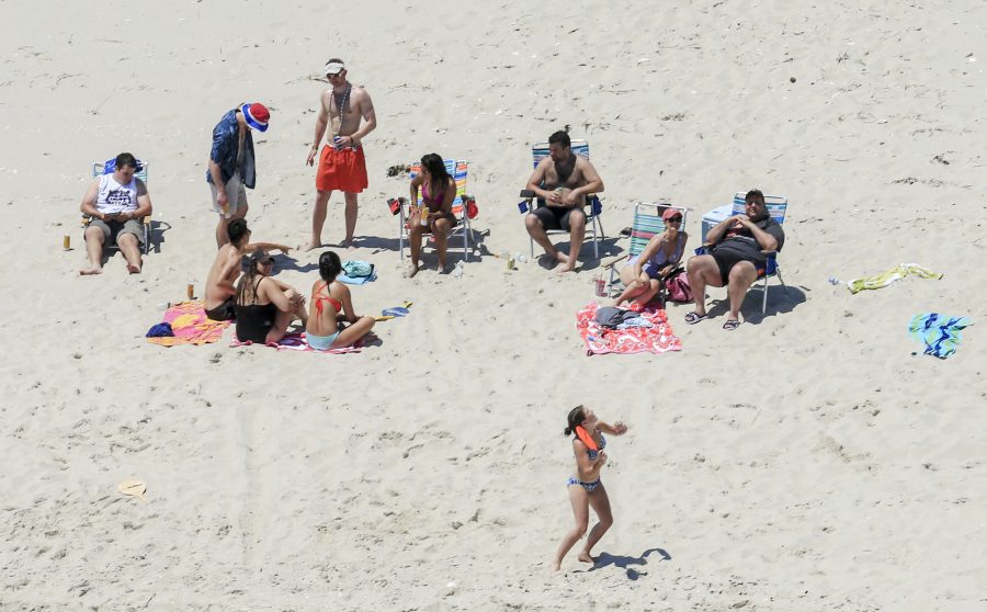 In this Sunday, July 2, 2017, photo, New Jersey Gov. Chris Christie, right, uses the beach with his family and friends at the governors summer house at Island Beach State Park in New Jersey. Christie is defending his use of the beach, closed to the public during New Jerseys government shutdown, saying he had previously announced his vacation plans and the media had simply caught a politician keeping his word. (Andrew Mills/NJ Advance Media via AP)