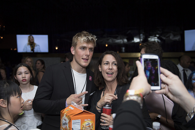 Jake Paul poses with fans at a Disney awards show