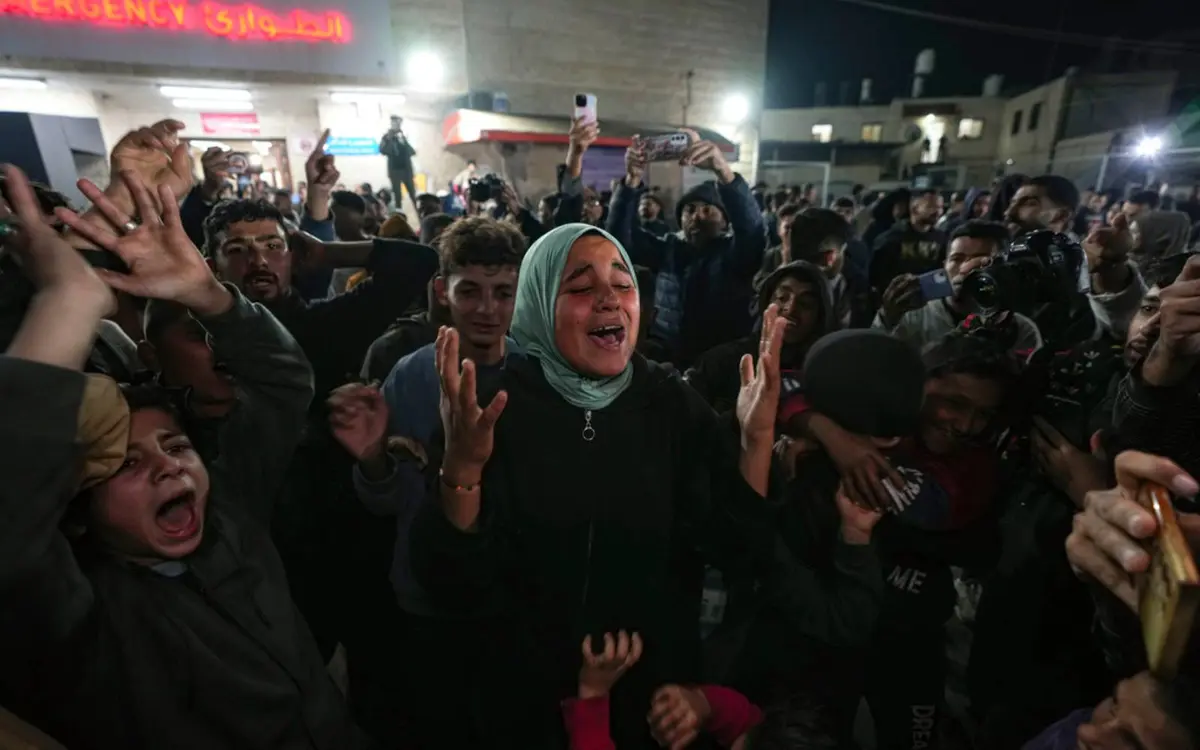 Palestinians celebrate the announcement of the ceasefire in Deir al-Balah. Image sourced from freemalaysiatoday.com