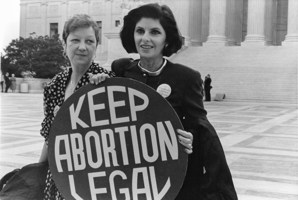 Norma McCorvey (Jane Roe) and her lawyer Gloria Allred on the steps of the Supreme Court, 1989. Image sourced from flickr.com.